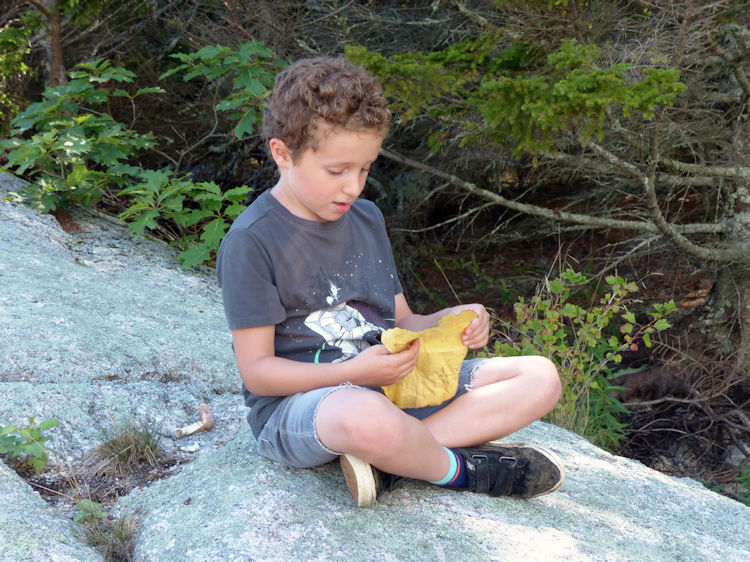 Zev examining treasure map he discovered in a washed up bottle