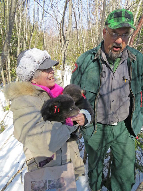 Judy holding cubs and talking with Randy